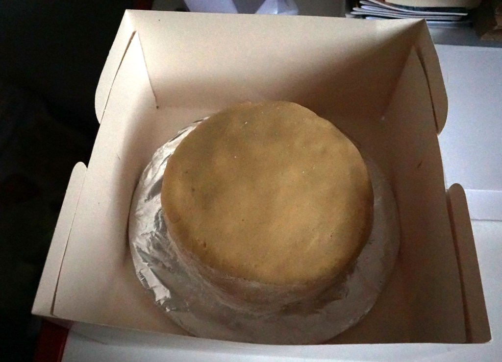 cake in box for almond paste to dry